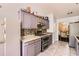 Well-equipped kitchen with gray cabinets, stainless steel appliances, and a glimpse into the dining room at 7450 Chads Cir, Jonesboro, GA 30236