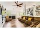 Cozy living room with a fireplace, plush seating, and natural light from the windows at 7450 Chads Cir, Jonesboro, GA 30236