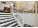 A staircase leading into a dining room featuring a neutral color palette and white accents at 7450 Chads Cir, Jonesboro, GA 30236