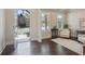 Bright foyer with dark hardwood floors, neutral walls, and a view of the home's exterior through the front door at 3065 Arbor Song Ct, Cumming, GA 30041
