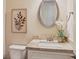 Cozy half bathroom featuring granite counters, neutral decor, and an oval mirror over the vanity at 3065 Arbor Song Ct, Cumming, GA 30041