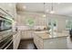 Modern kitchen boasting stainless steel appliances, granite countertops, and a center island with bar seating at 3065 Arbor Song Ct, Cumming, GA 30041