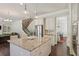 Bright kitchen features a granite island, stainless steel appliances, and seamless flow to living and dining areas at 3065 Arbor Song Ct, Cumming, GA 30041