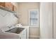 Functional laundry room with modern appliances and ample storage space at 3065 Arbor Song Ct, Cumming, GA 30041