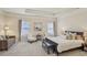 Spacious main bedroom with a tray ceiling, large windows, and ample seating creating a relaxing retreat at 3065 Arbor Song Ct, Cumming, GA 30041