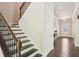 Elegant staircase with wooden railing and steps, leading to the upper level of the home at 3065 Arbor Song Ct, Cumming, GA 30041