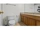 Functional bathroom featuring a toilet, vanity with sink, and a mirror at 5570 Stonewood Ct, Norcross, GA 30093