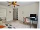 Cozy bedroom with ceiling fan, desk area, and access to an en-suite bathroom at 5570 Stonewood Ct, Norcross, GA 30093