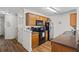 Well-equipped kitchen with stainless steel appliances, wood cabinets, and a functional cooking space at 5570 Stonewood Ct, Norcross, GA 30093