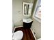 Powder room featuring a modern vanity, mirror, toilet, and window, all in a compact space at 1277 4Th Ave, Auburn, GA 30011