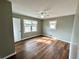 Bedroom featuring wood floors, neutral walls, and ample natural light from two large windows at 1277 4Th Ave, Auburn, GA 30011
