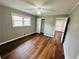 Bedroom featuring closet, wood floors, a ceiling fan, a window, and en suite access at 1277 4Th Ave, Auburn, GA 30011