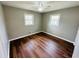 Empty bedroom featuring wood-look floors, neutral paint, and natural light from two windows at 1277 4Th Ave, Auburn, GA 30011