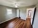 Bedroom featuring closet, wood floors, a ceiling fan, a window, and neutral paint at 1277 4Th Ave, Auburn, GA 30011