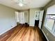 Bedroom featuring en suite access, a closet, wood floors, a ceiling fan, and natural light at 1277 4Th Ave, Auburn, GA 30011