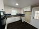 Renovated kitchen showcasing white cabinets, stainless steel appliances, and modern finishes at 1277 4Th Ave, Auburn, GA 30011