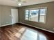 Bright living room featuring wood floors, a large window, and a ceiling fan for comfortable living at 1277 4Th Ave, Auburn, GA 30011