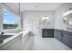 Modern bathroom featuring double vanity, an open-air tub, tile flooring, and a large window at 175 Paislee Park (Lot # 11 Paislee Park) Dr, Fayetteville, GA 30215