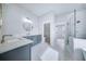 Bright bathroom featuring double vanity with marble counters, stylish fixtures, and glass shower at 175 Paislee Park (Lot # 11 Paislee Park) Dr, Fayetteville, GA 30215