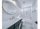 Bathroom with a large round mirror, a tub, and a walk-in shower at 175 Paislee Park (Lot # 11 Paislee Park) Dr, Fayetteville, GA 30215