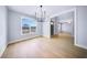 Bright dining room featuring hardwood floors, large windows, and a modern chandelier at 175 Paislee Park (Lot # 11 Paislee Park) Dr, Fayetteville, GA 30215