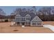 Inviting two-story home featuring a covered front porch and a well-manicured lawn at 175 Paislee Park (Lot # 11 Paislee Park) Dr, Fayetteville, GA 30215