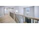 Bright hallway with hardwood floors, iron railing, and a view overlooking the front entry at 175 Paislee Park (Lot # 11 Paislee Park) Dr, Fayetteville, GA 30215