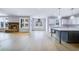 Spacious living room with wood floors, a stone fireplace and a kitchen with an island with marble countertops at 175 Paislee Park (Lot # 11 Paislee Park) Dr, Fayetteville, GA 30215