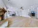 Open-concept living area with a stone fireplace, hardwood floors, and views to the kitchen at 175 Paislee Park (Lot # 11 Paislee Park) Dr, Fayetteville, GA 30215