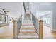 Elegant staircase with wood treads, black iron railings, and a light-filled foyer at 175 Paislee Park (Lot # 11 Paislee Park) Dr, Fayetteville, GA 30215