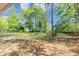 The lush green backyard is spacious with large trees and shady spots at 190 Sunrise Cir, Riverdale, GA 30274