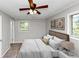 Bedroom with a bed, pillows, framed art, lamps, and a ceiling fan at 190 Sunrise Cir, Riverdale, GA 30274