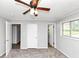 Bedroom with neutral walls, carpet, a ceiling fan, and three doors at 190 Sunrise Cir, Riverdale, GA 30274