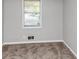 Bedroom featuring neutral carpeting, a window, and gray painted walls at 190 Sunrise Cir, Riverdale, GA 30274