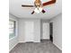 Bedroom featuring neutral carpeting, gray walls, a ceiling fan, and a window at 190 Sunrise Cir, Riverdale, GA 30274