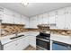 Well-lit kitchen with ample white cabinetry, tiled backsplash, and stainless steel oven and hood at 190 Sunrise Cir, Riverdale, GA 30274