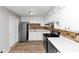 Bright kitchen featuring white cabinets, stainless steel appliances, and a stylish mosaic backsplash at 190 Sunrise Cir, Riverdale, GA 30274