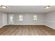 Bright and airy living room with gleaming hardwood floors and neutral paint at 190 Sunrise Cir, Riverdale, GA 30274