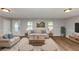 Stylish living room featuring comfortable seating, area rug, and ample natural light at 190 Sunrise Cir, Riverdale, GA 30274
