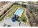 Aerial view showcasing the community pool, playground, and parking at 3564 Nathan Farm Ln, Buford, GA 30519