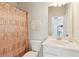Bathroom featuring a decorative shower curtain, white cabinets and neutral walls at 3564 Nathan Farm Ln, Buford, GA 30519