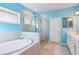 Bright bathroom with a soaking tub, glass shower, and a double vanity at 3564 Nathan Farm Ln, Buford, GA 30519