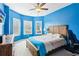 Blue bedroom featuring a ceiling fan, a large bed and bay windows at 3564 Nathan Farm Ln, Buford, GA 30519
