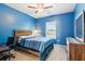Cozy blue bedroom with a wooden bed frame, a ceiling fan, and neutral carpet at 3564 Nathan Farm Ln, Buford, GA 30519