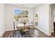 Bright breakfast nook with a table and chairs next to a large window and a door to the outside at 3564 Nathan Farm Ln, Buford, GA 30519