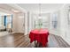 Bright dining room featuring hardwood floors, and three large windows providing natural light at 3564 Nathan Farm Ln, Buford, GA 30519