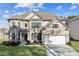 Beautiful two-story home featuring a brick facade, attached garage, and well-manicured front lawn at 3564 Nathan Farm Ln, Buford, GA 30519