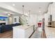 Modern kitchen with an island, granite countertops, stainless steel appliances, and opens to living room at 3564 Nathan Farm Ln, Buford, GA 30519