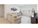 Bright and open living room with a large sofa, big windows, and natural light at 3564 Nathan Farm Ln, Buford, GA 30519