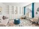 Bright living room with a large bookshelf, stylish chairs, and an area rug at 3564 Nathan Farm Ln, Buford, GA 30519